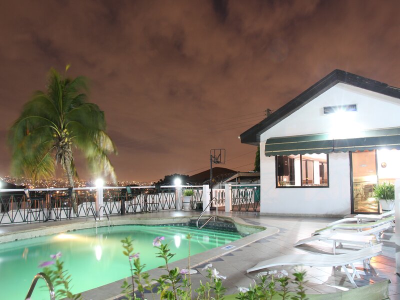Illuminated pool with city view at night